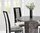 Round grey marble dining table with 4 fabric chairs
