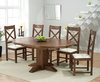 Extending round dark oak dining table and 6 chairs