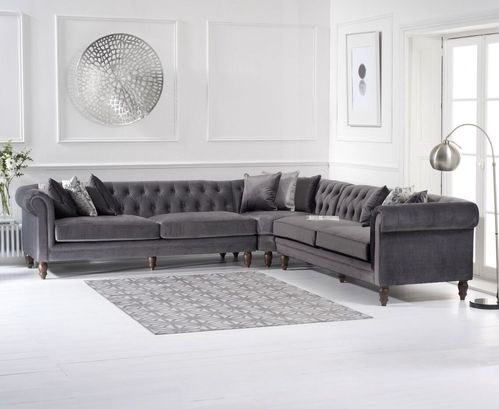 Grey plush velvet corner sofa with cushions