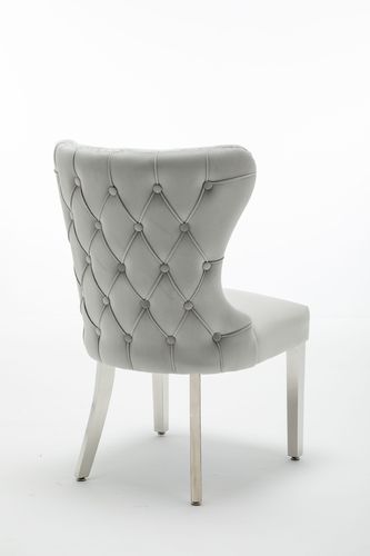 Light grey velvet button backed dining chairs